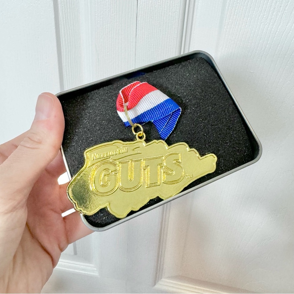 Nick Box exclusive Global GUTS gold medal necklace in box
